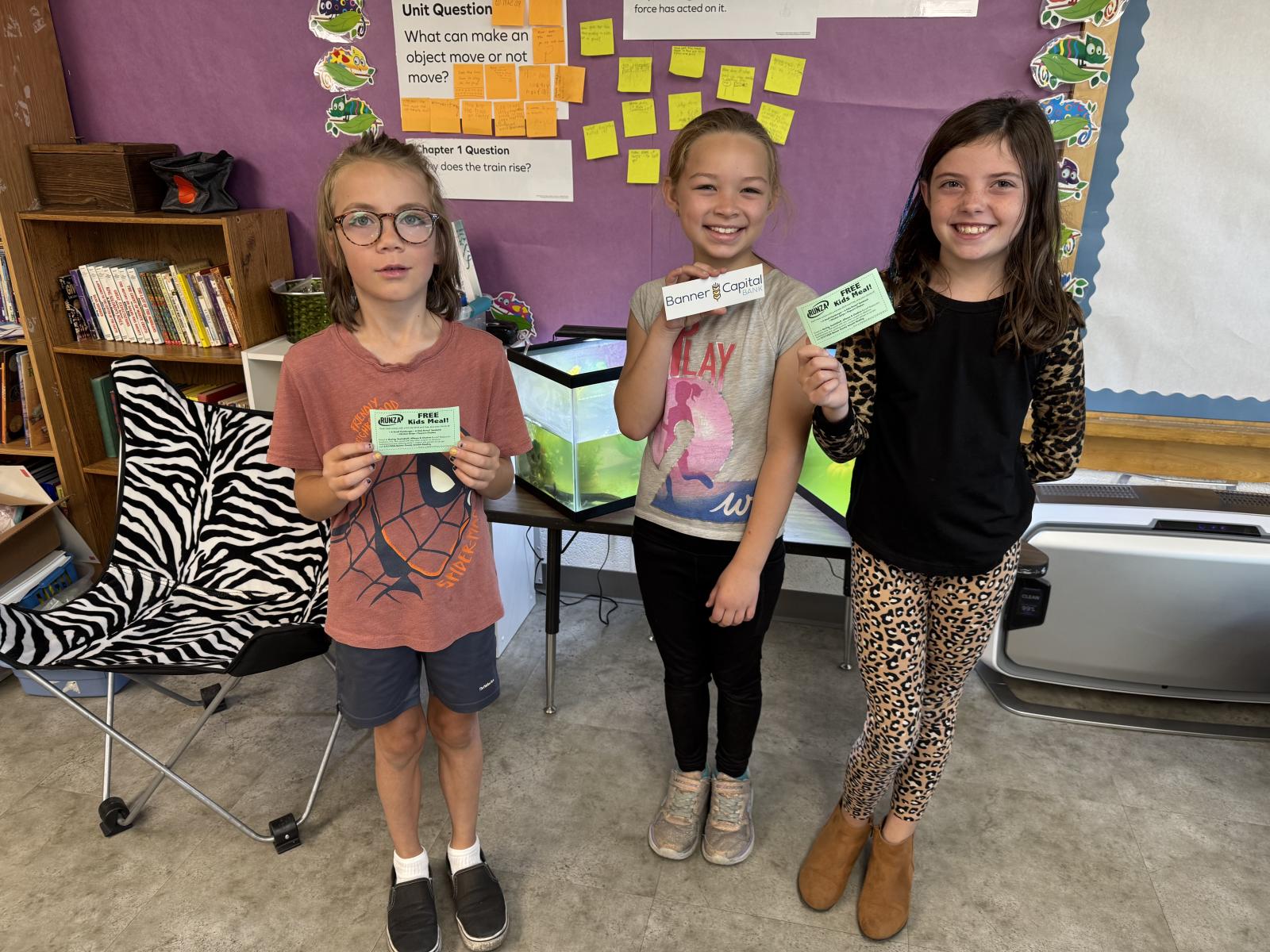 Students holding prizes for  reading